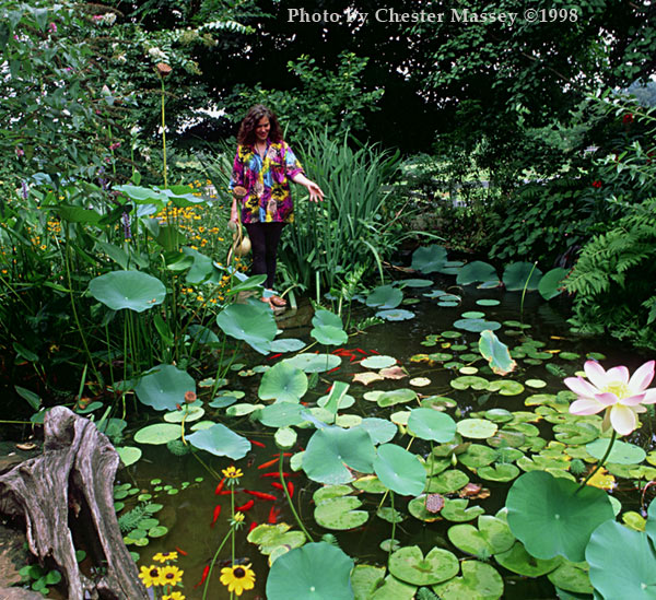 The artist feeding her pet goldfish at her Knoxville, Tennessee farm.